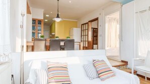 A bedroom with a bed, pillows, and a view into the kitchen. - Joan Sarda by Interhome (Roses)