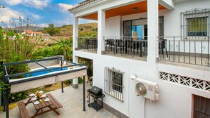 A two-story house with a balcony, outdoor seating, and a swimming pool. - Delfines by Interhome (Benajarafe)