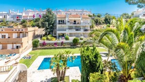 A residential area with a swimming pool, palm trees, and a view of the sea. - Els Jardins III by Interhome (Roses)