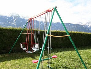 Enjoy a leisurely swing in our serene outdoor space, surrounded by a beautifully manicured lawn and breathtaking mountain views.