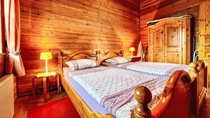 A wooden room with a bed, nightstands, and a wardrobe. - Löwenzahn by Interhome (Adenau)