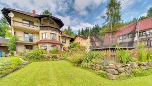 A multi-story house with a well-maintained lawn and garden. - Kubaczka by Interhome (Wisla)
