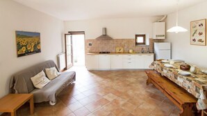 A compact living space with a kitchenette, a dining area with a bench, and a sofa. - I Noccioli by Interhome (Rufina)