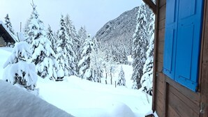 A snowy landscape with a wooden cabin and a mountain in the background. - Vacation home Dufaux by Interhome (Champex)