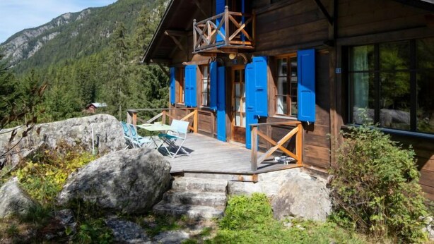 A wooden cabin with a balcony, surrounded by mountains and greenery. - Vacation home Dufaux by Interhome (Champex)