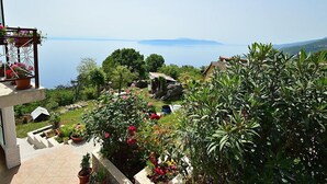 A terrace with potted plants and a view of the sea. - Apartment Josip by Interhome (Lovran/Tuliševica)