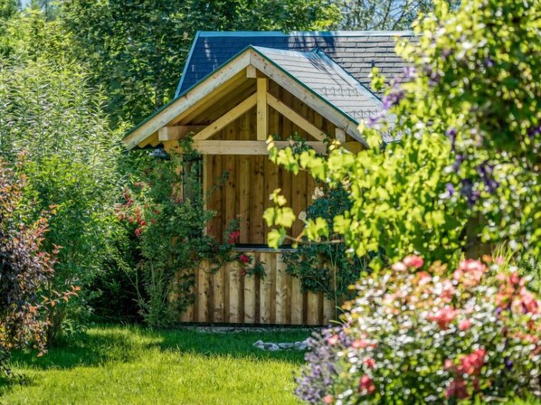 Escape to a serene garden retreat surrounded by lush greenery and vibrant flowers.