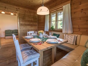 Enjoy meals together at the dining table for four, surrounded by a comfortable sofa and warm ambiance.