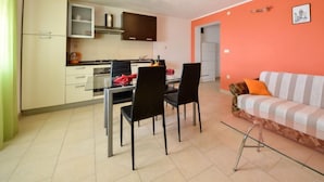 A compact living space with a kitchenette, dining area, and a sofa. - Apartment Milin by Interhome (Murter/Jezera)