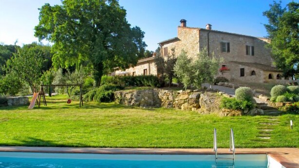 A pool with a stone building in the background, surrounded by greenery and a clear sky. - San Lorenzo by Interhome (Gambassi Terme)