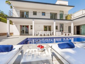 A modern house with a swimming pool, outdoor furniture, and a dining area. - Palmbeach by Interhome (Lloret de Mar)