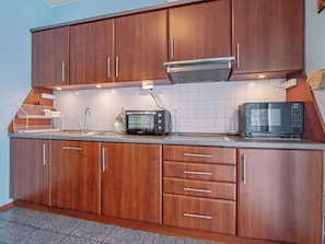 Fridge, microwave, cookware/dishes/utensils, dining tables