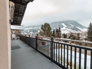 A balcony with a view of snow-covered mountains and a road. - Vacation home Riki by Interhome (Bruck)