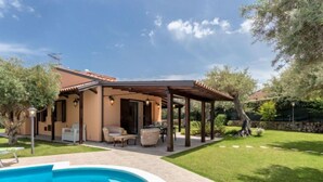 A house with a swimming pool, patio furniture, and a covered outdoor area. - Jancaliva by Interhome (Cefalù)