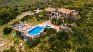A Mediterranean-style villa with a swimming pool, surrounded by lush greenery and mountains. - Cala Torta Na Moli by Interhome (Cala Torta)