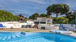 A swimming pool with a clear blue water surface, surrounded by lounge chairs and a small deck area. - Mercury by Interhome (Lloret de Mar)