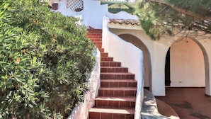 A staircase leading to a building with a white facade and red-tiled roof. - Villa Selena by Interhome (Valledoria)