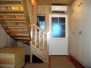 A wooden staircase leading to a door with frosted glass panels. - Kurrela by Interhome (Kiuruvesi)