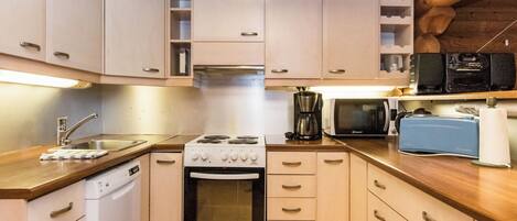 A compact kitchen with a stove, oven, microwave, and a dishwasher.