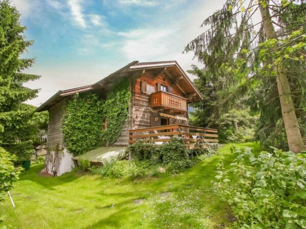 A wooden chalet with a balcony, surrounded by lush greenery. - Waldner by Interhome (Telfs)