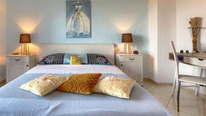 A bedroom with a bed, two bedside tables, a chair, and a painting on the wall. - Apartment Lili by Interhome (Poreč)