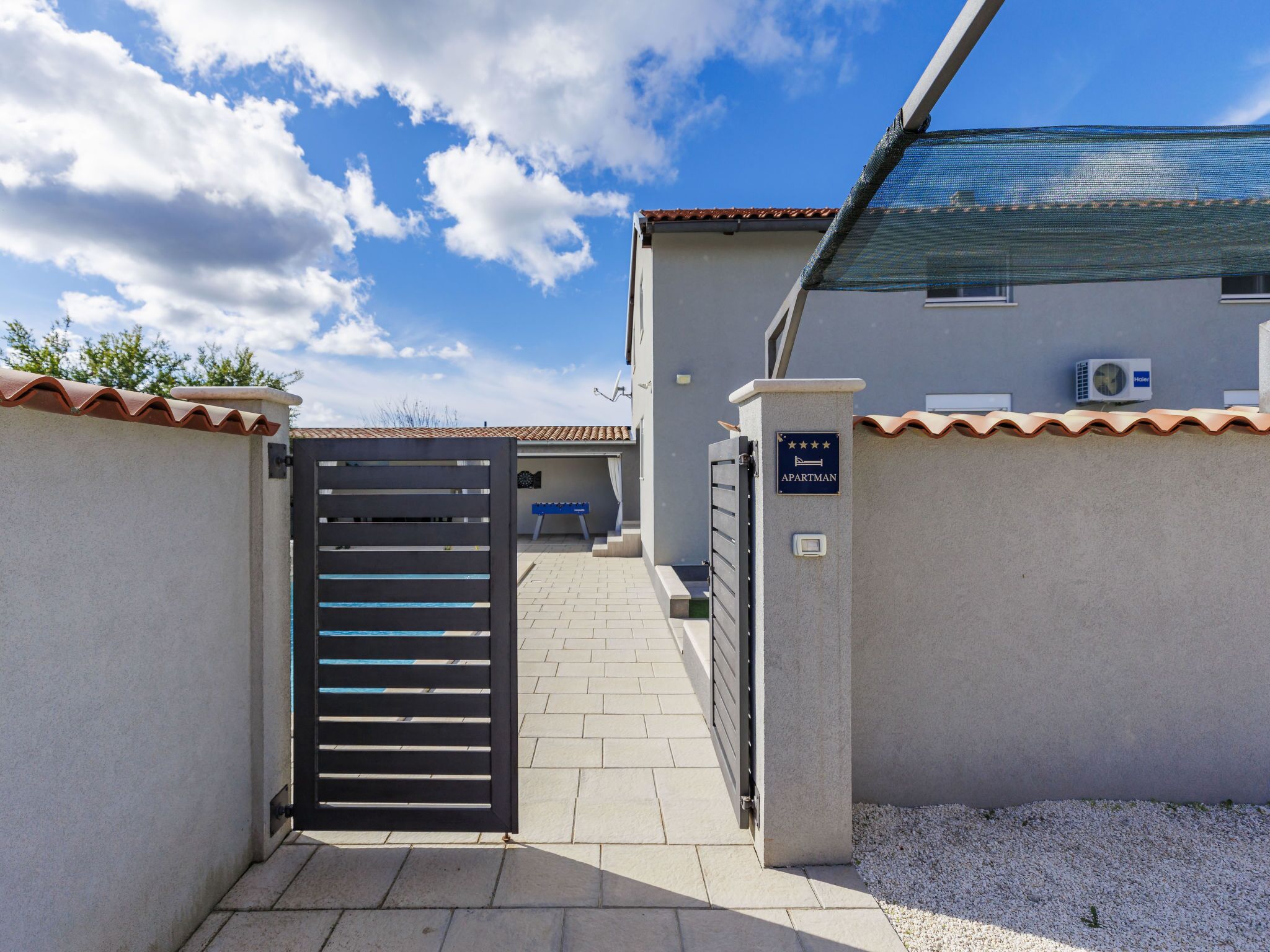 A gated entrance to a building with a sign indicating it is an apartment.