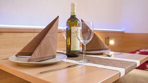 A table set with a bottle of wine, two glasses, and a fork. - Bella Monte by Interhome (Pettneu am Arlberg)
