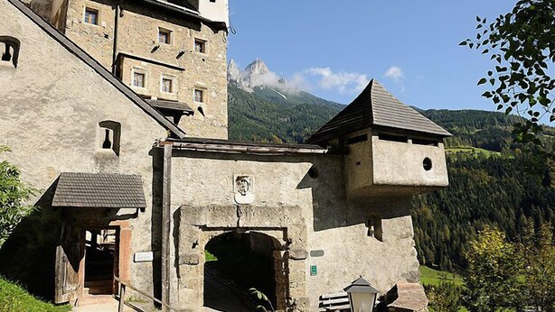 A historic stone building with multiple levels, a central entrance, and a small bell tower. - Apartment Rosi by Interhome (Werfenweng)