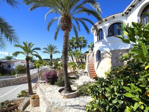 Stroll through the tranquil grounds, surrounded by lush greenery and arched windows of this Mediterranean-style building.