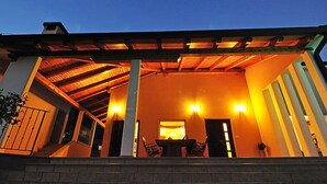 A covered outdoor area with a reception desk, seating, and a staircase leading to an upper level. - Vacation home Vesna by Interhome (Buzet)