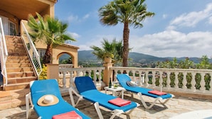 A terrace with sun loungers, a pool, and a view of the landscape. - Bella Vista by Interhome (Calonge)