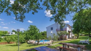 A villa with a swimming pool, outdoor seating, and a well-maintained garden. - Apartment  Ana by Interhome (Porec/Jehnici)