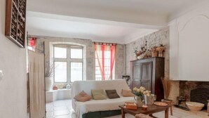 Una sala de estar acogedora con sofá, mesa de centro de madera y chimenea.