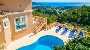 A poolside area with a clear view of the sea and surrounding landscape. - La Perla by Interhome (Moraira)