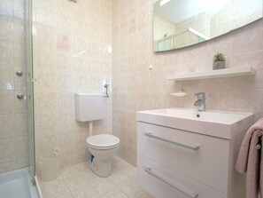 A bathroom with a toilet, sink, and shower. - Aquanur by Interhome (Vodice/Tribunj)