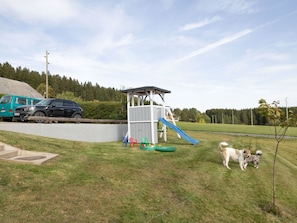 Guests can enjoy a play area with a slide on the lush lawn.