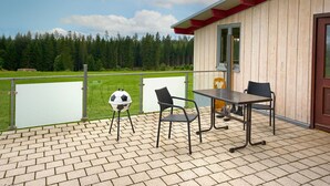 A wooden building with a balcony, a soccer ball, and two chairs. - Fürderer by Interhome (Eisenbach)