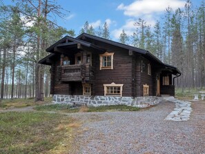 A log cabin with a stone foundation, multiple windows, and a porch. - Vacation home Siula by Interhome (Kuusamo)