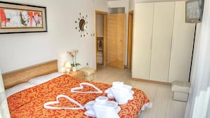 A hotel room with a large bed, a wardrobe, a television, and a painting on the wall. - Vacation home Nicole by Interhome (Opatija/Pobri)