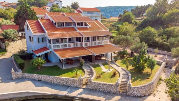 A large, two-story house with a swimming pool and a stone wall surrounding the property. - Apartment Mare 8 by Interhome (Rab/Kampor)