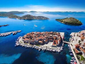 An aerial view of a coastal town with a central square, surrounded by water and small islands. - Aquanur by Interhome (Vodice/Tribunj)