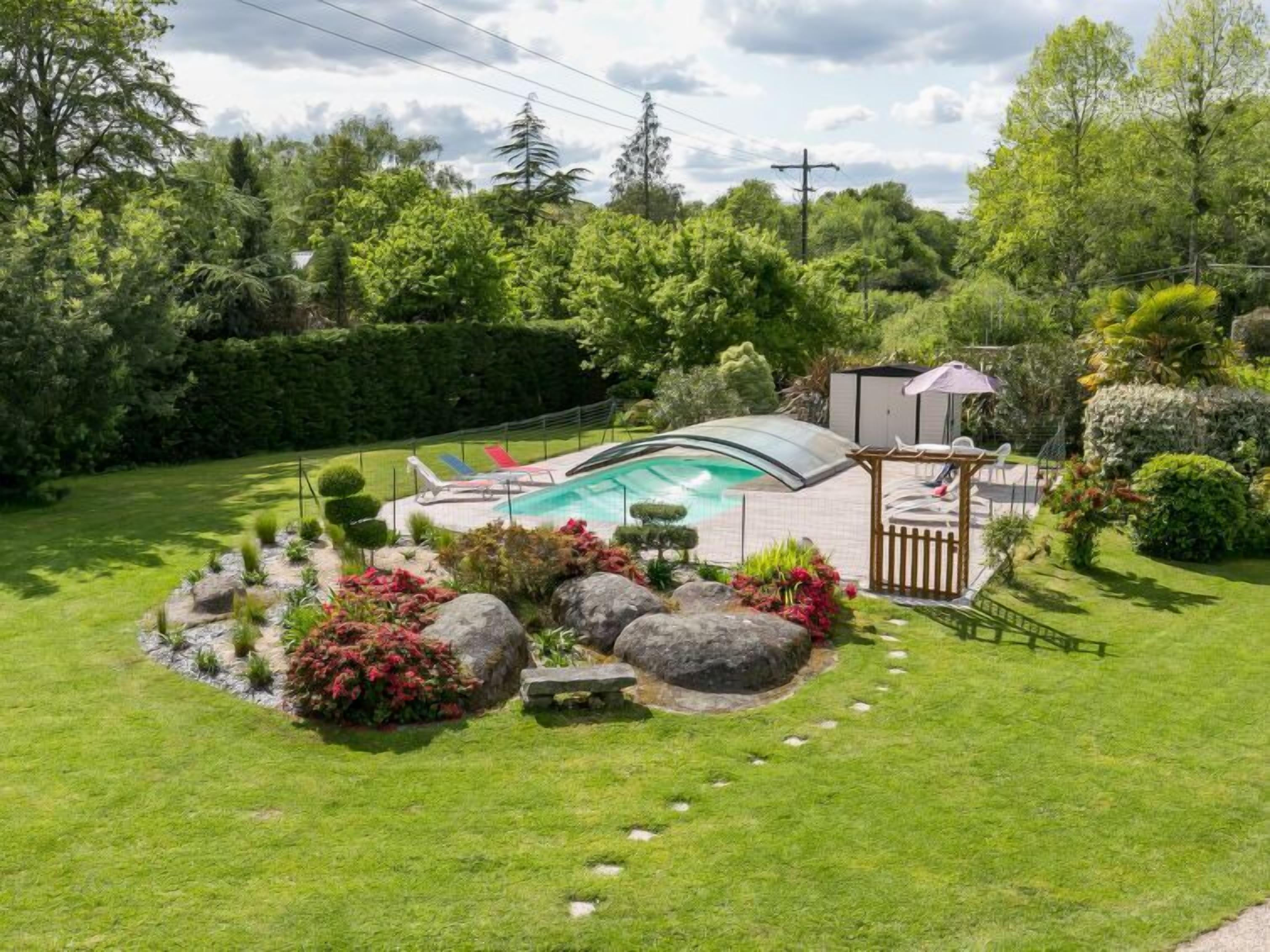 A backyard with a swimming pool, a gazebo, and a well-maintained lawn.