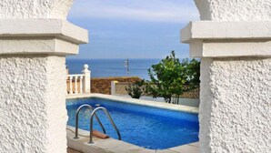 A pool with a view of the sea, framed by white pillars. - Vacation home Avalon by Interhome (Calpe/Calp)