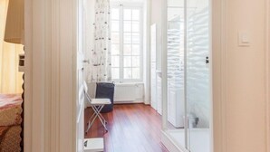 A narrow hallway with a radiator, a folding chair, and a small step leading to a door. - Le Cyclamen by Interhome (Courseulles)