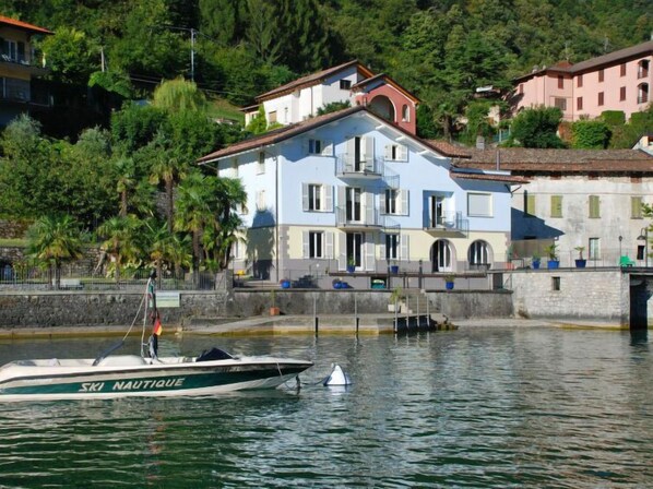 Waterfront property with a multi-story building and balconies overlooking the water.