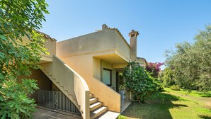 A house with a curved staircase leading to a covered porch. - Vacation home Carlo by Interhome (Villasimius)