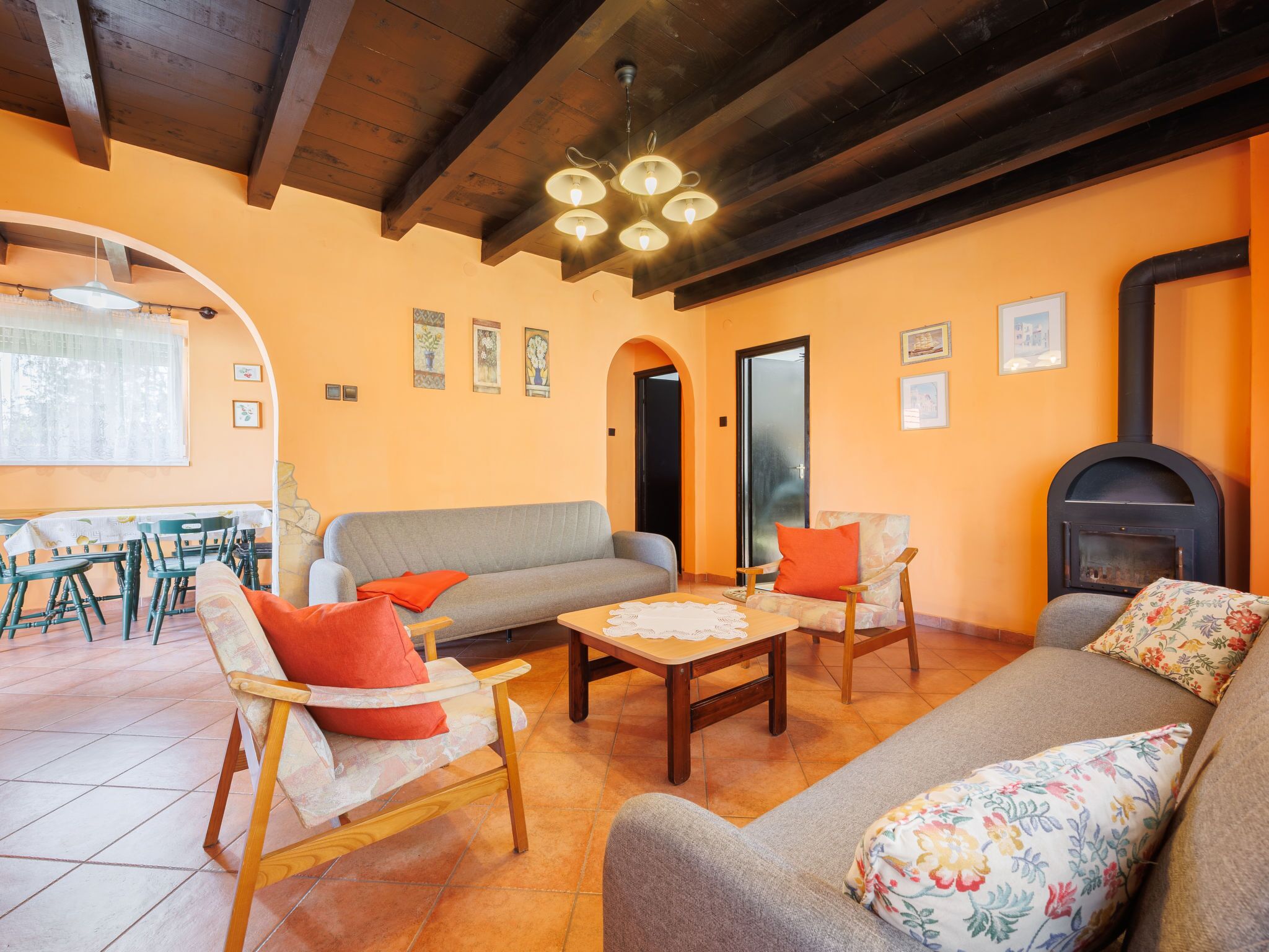 Un salon chaleureux avec un canapé, des fauteuils, une table basse et une cheminée.