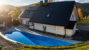A house with a swimming pool, a stone chimney, and a view of the surrounding landscape. - Willa Sonia by Interhome (Zawoja)