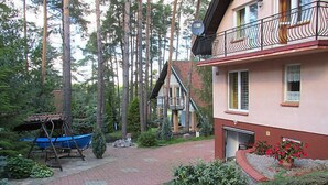 A residential area with a house, a swing set, and a small garden. - Mielno 2 by Interhome (Grunwald)