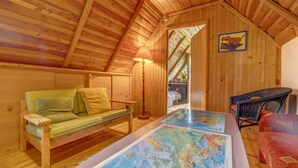 A cozy attic room with wooden walls and a sloped ceiling. - Vacation home Hatale by Interhome (Rzyki)